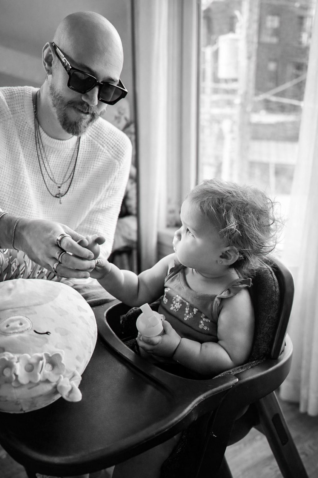 Joshua holding Richie's hand at home